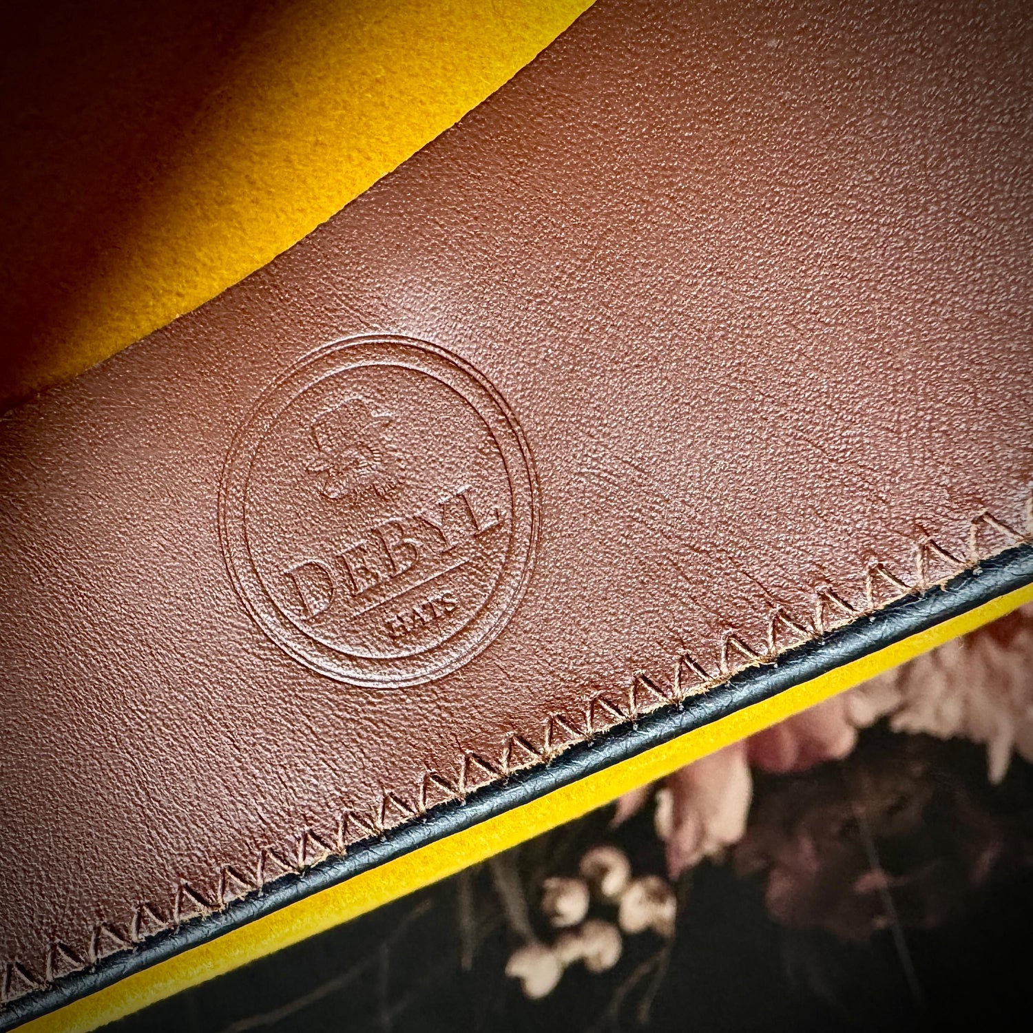 Brown leather sweatband with DeByl Hats logo stamp.